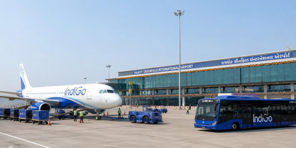 Rajkot to Dubai Flight Routes: Best Transit Options, Airlines & Airports 1 Aircraft on the tarmac at Rajkot Greenfield International Airport with the terminal building behind it