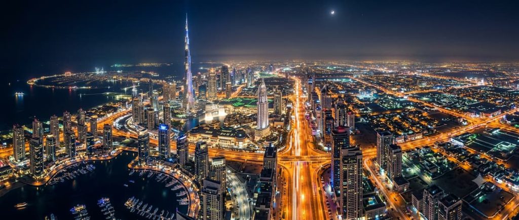 Global Village Dubai: The AED 25 World Tour — Season Dates, Tickets, and How to Do It Right 3 Create one banner image for this topic Aerial view of the Dubai cityscape glowing at night
image should be real