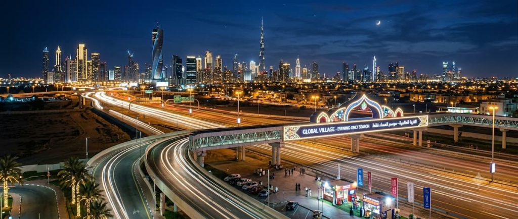 Global Village Dubai: The AED 25 World Tour — Season Dates, Tickets, and How to Do It Right 1 Dubai illuminated at night, the setting for Global Village's evening-only season