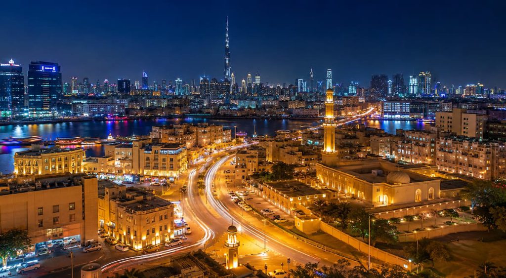 Old Dubai Souks: Gold, Spice, Textile — and the Customs Rules Every Indian Buyer Must Know 2 Illuminated streets of Dubai at night near the old city