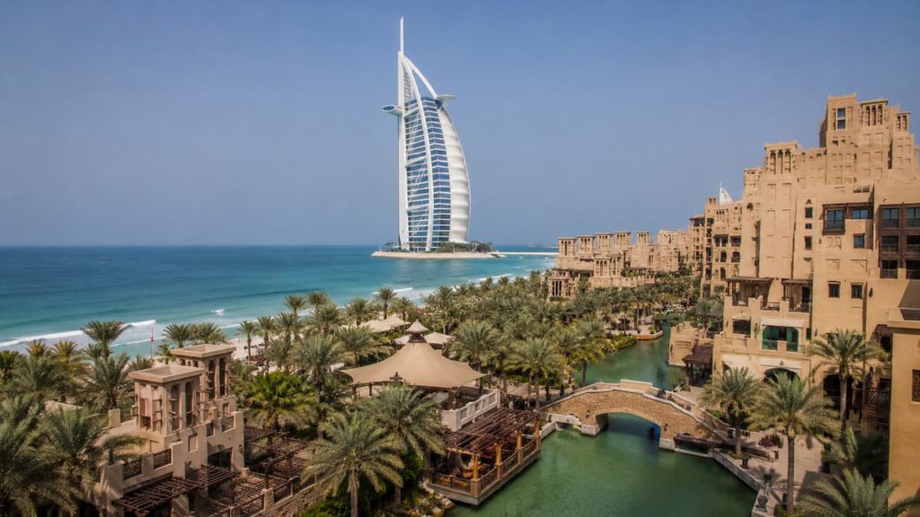 Which Dubai Beach Should You Actually Choose 2 View of Burj Al Arab with Souk Madinat Jumeirah and palm trees along the Jumeirah coastline